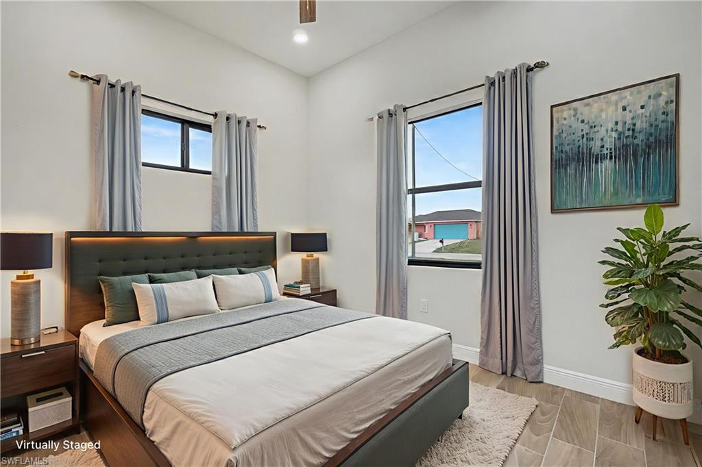 Bedroom with wood finish floors, a ceiling fan, and recessed lighting