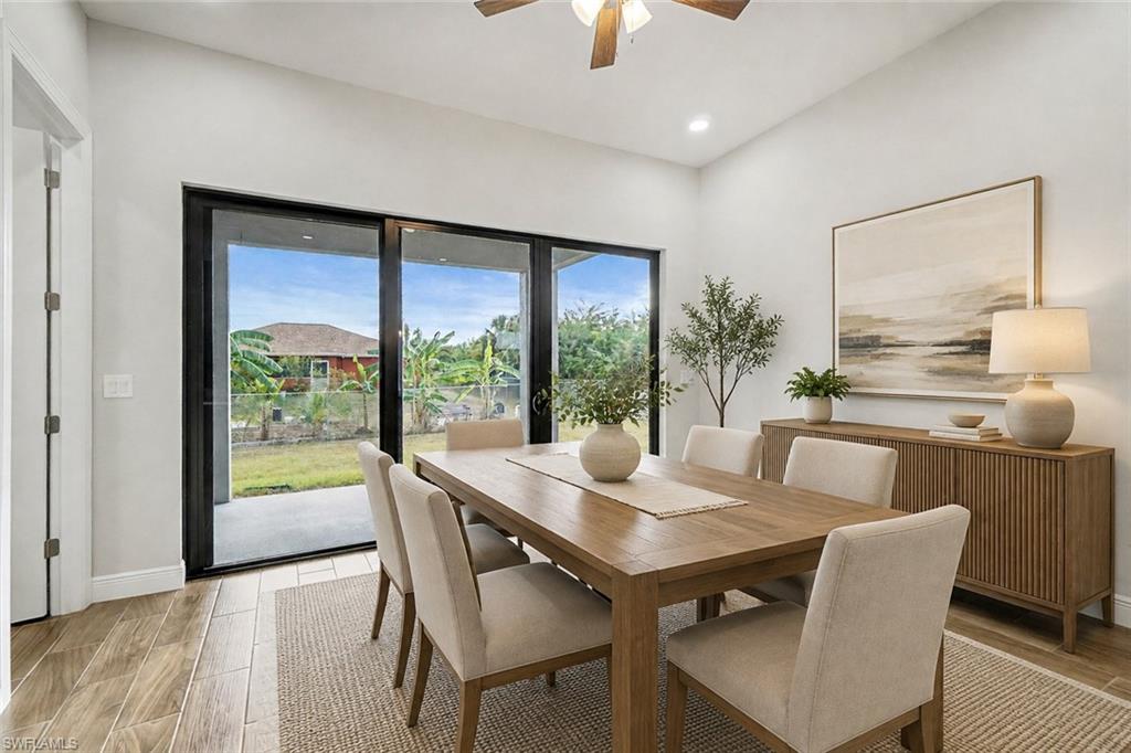 Wood-finish flooring, recessed lighting, and a ceiling fan with integrated lighting