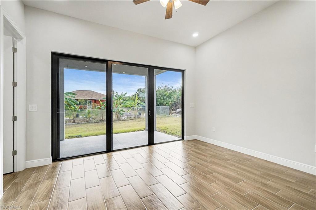 Unfurnished room with wood tiled floors, ceiling fan, and recessed lighting