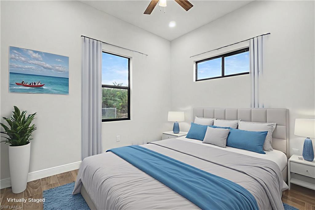 Bedroom featuring wood finished floors, ceiling fan, and recessed lighting