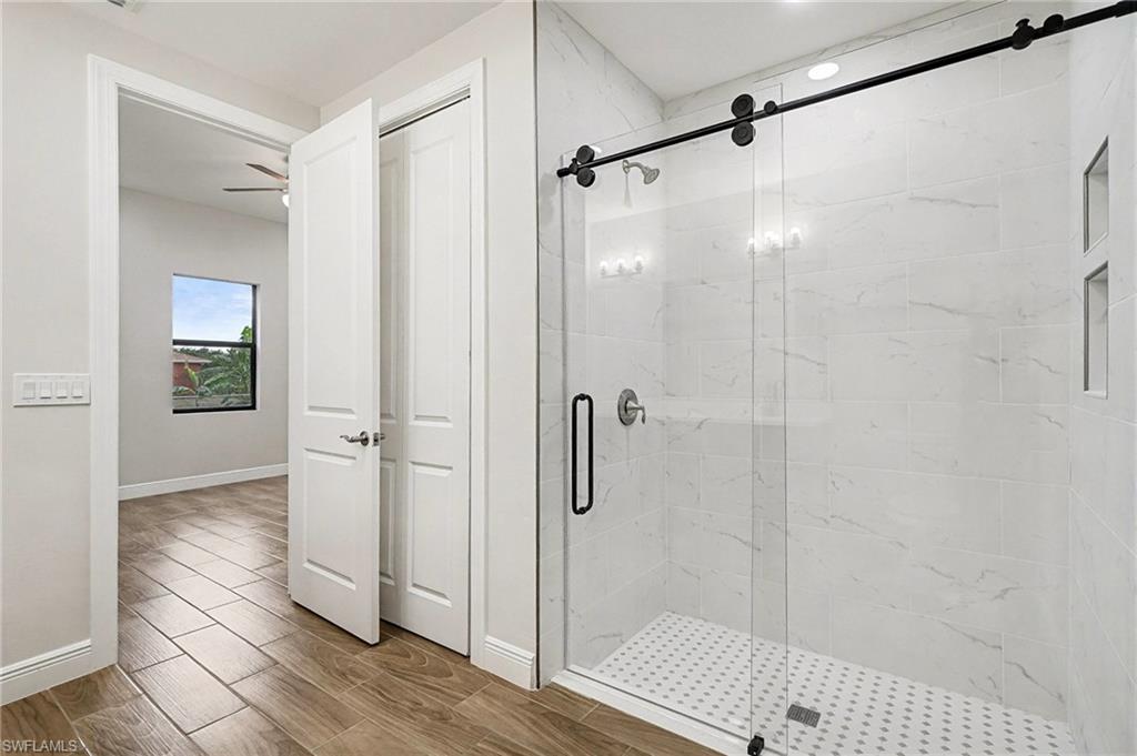 Bathroom featuring a stall shower and wood finish floors