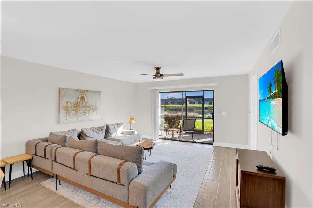 Living room with wood tiled floors and ceiling fan