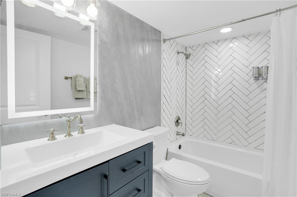 Bathroom with shower / bath combo and vanity