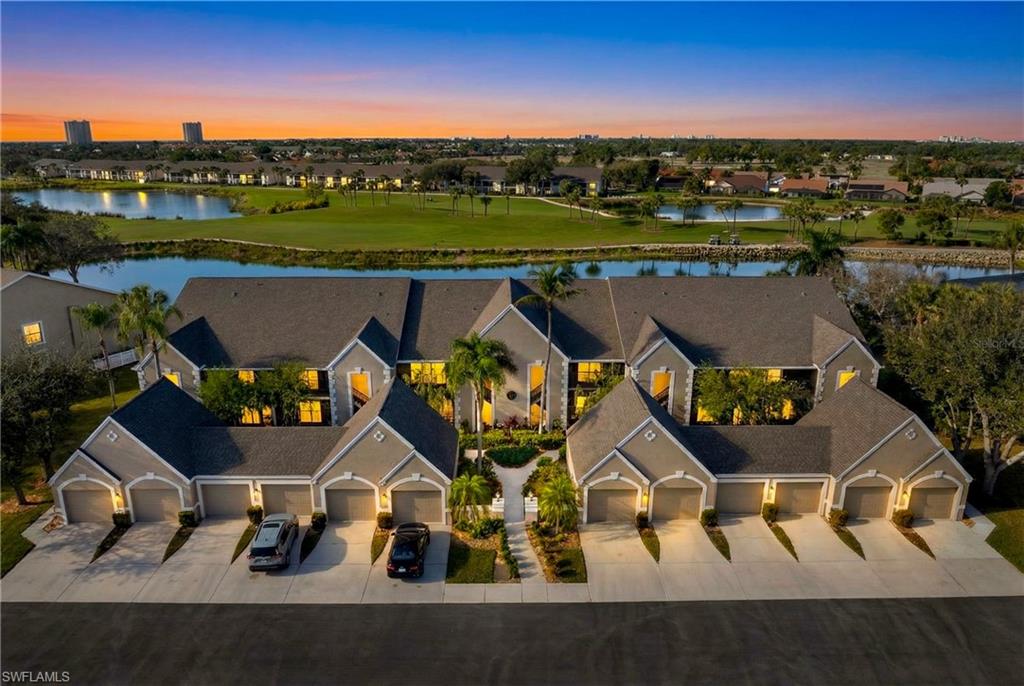 Aerial view at dusk of a water view and a residential view