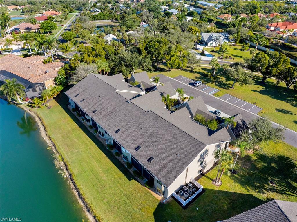 Aerial perspective of suburban area featuring a nearby body of water