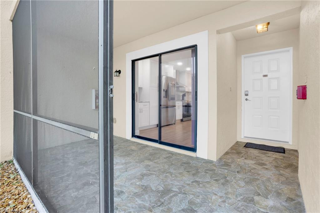 Entrance to property with stucco siding