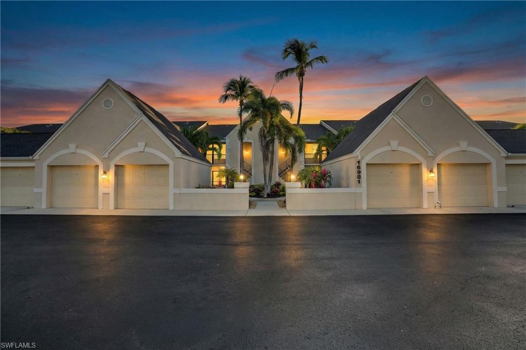 View of front of home with solar panels and stucco siding
