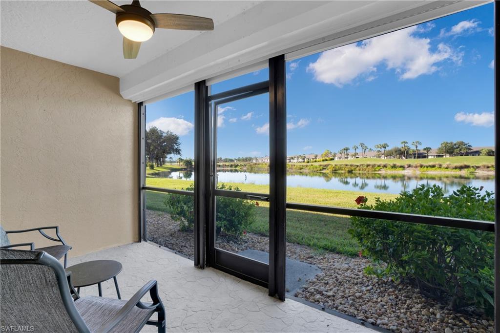 Sunroom with a water view and ceiling fan