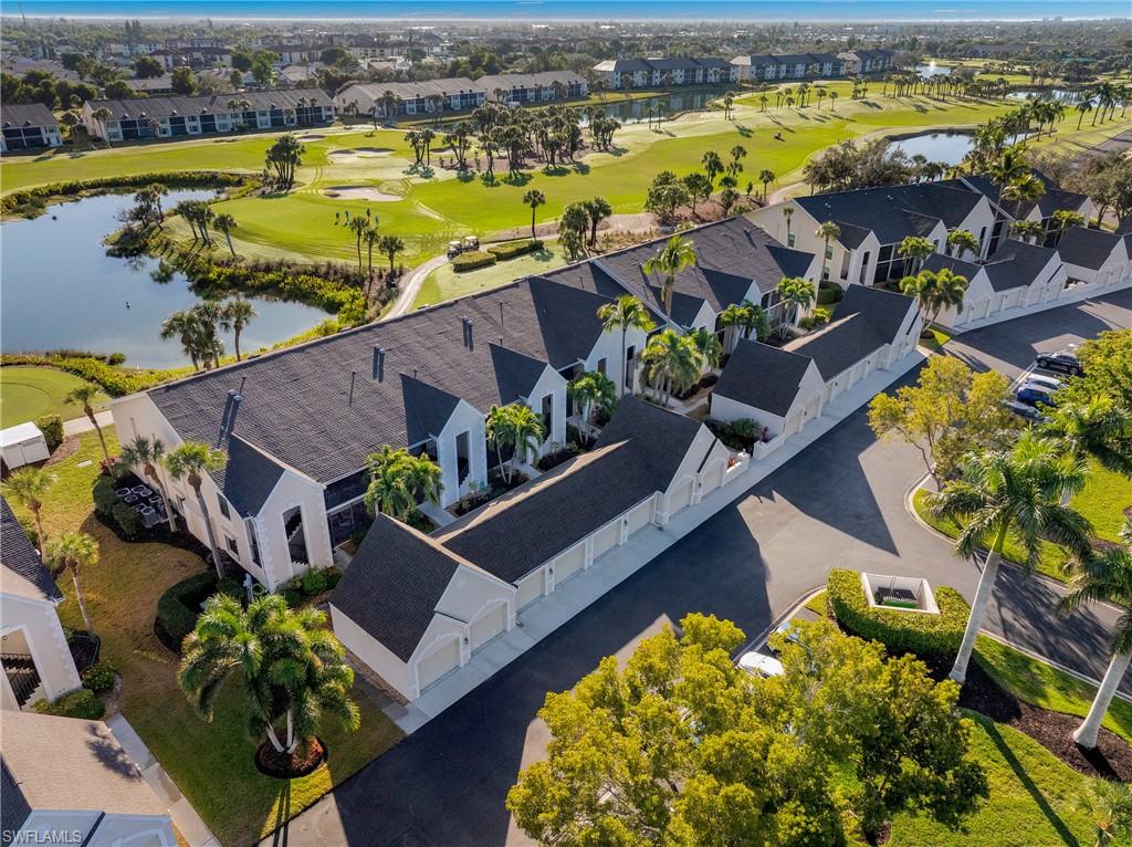 Aerial view of residential area with a large body of water and a golf club