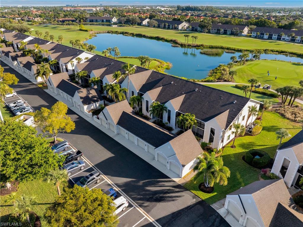 Aerial view of residential area with a large body of water and a golf course