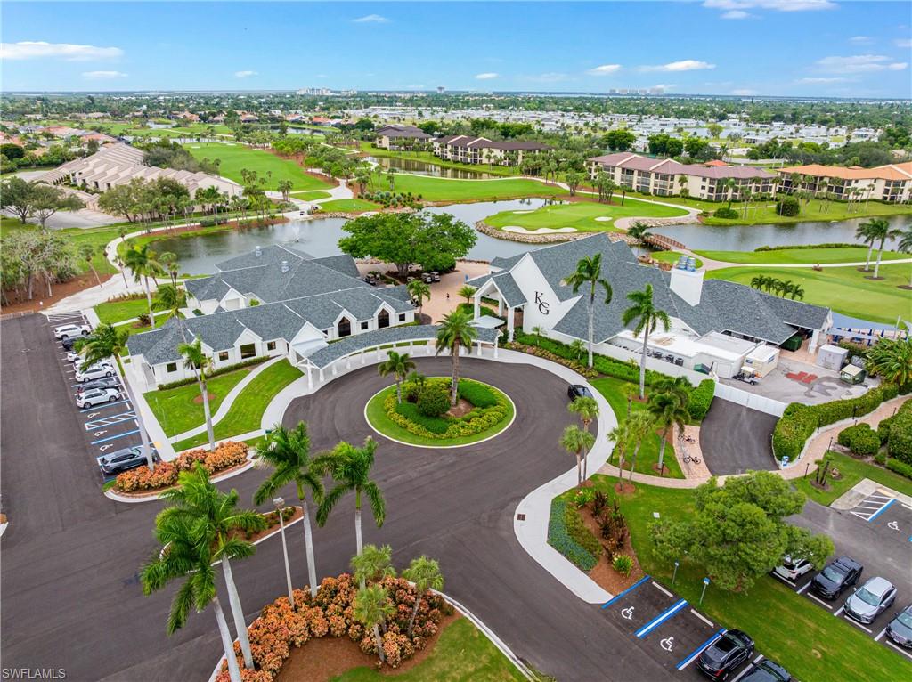 Aerial view of residential area with a golf course and a large body of water