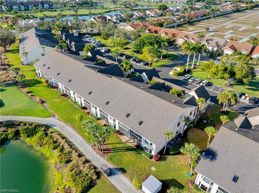 Aerial perspective of suburban area featuring a nearby body of water