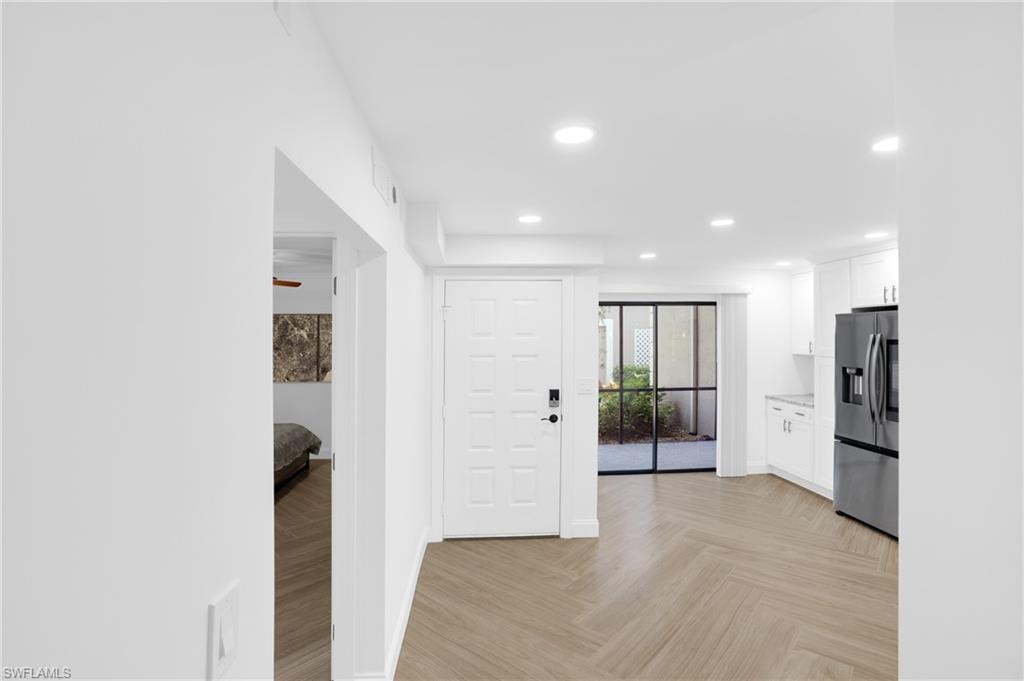 Kitchen featuring white cabinetry, stainless steel fridge with ice dispenser, recessed lighting, and ceiling fan