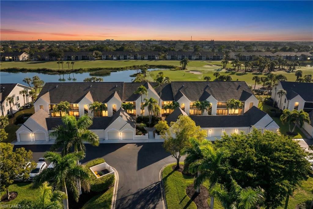 Aerial view of property and surrounding area with a nearby body of water, nearby suburban area, and a local golf course