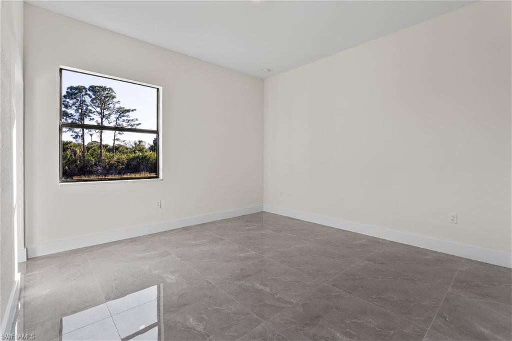 Empty room featuring light marble finish floors