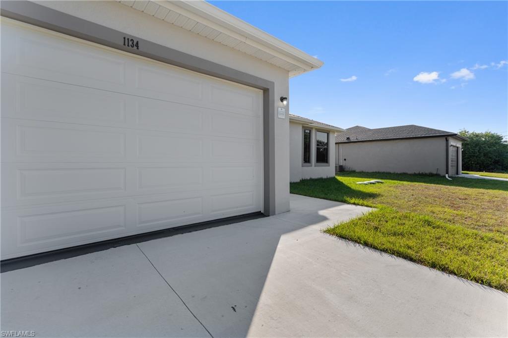 Garage featuring concrete driveway