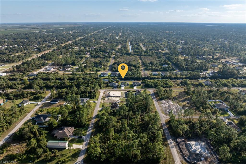 Aerial overview of property's location with nearby suburban area