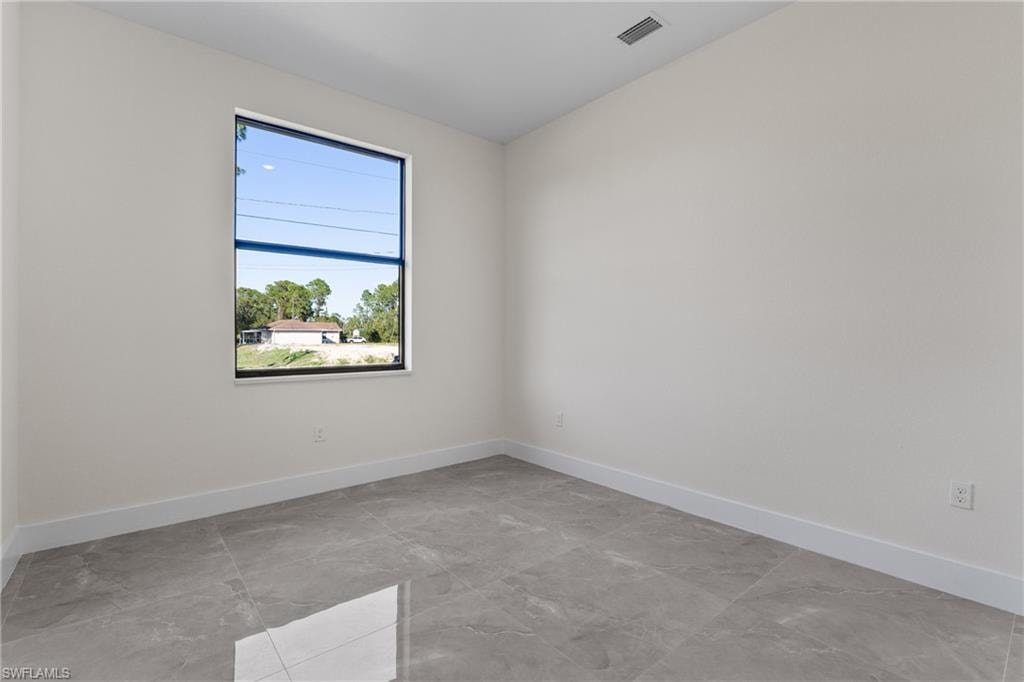 Empty room featuring baseboards and light marble finish flooring