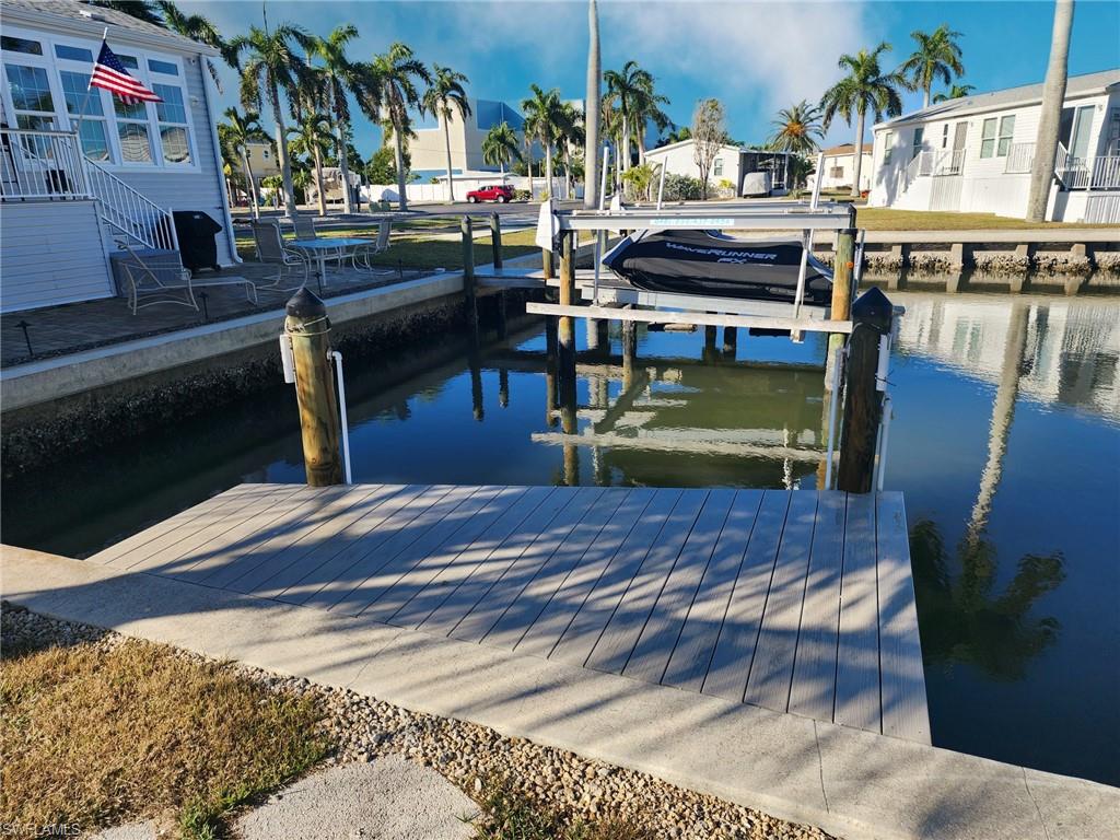 Dock featuring boat lift and a water view