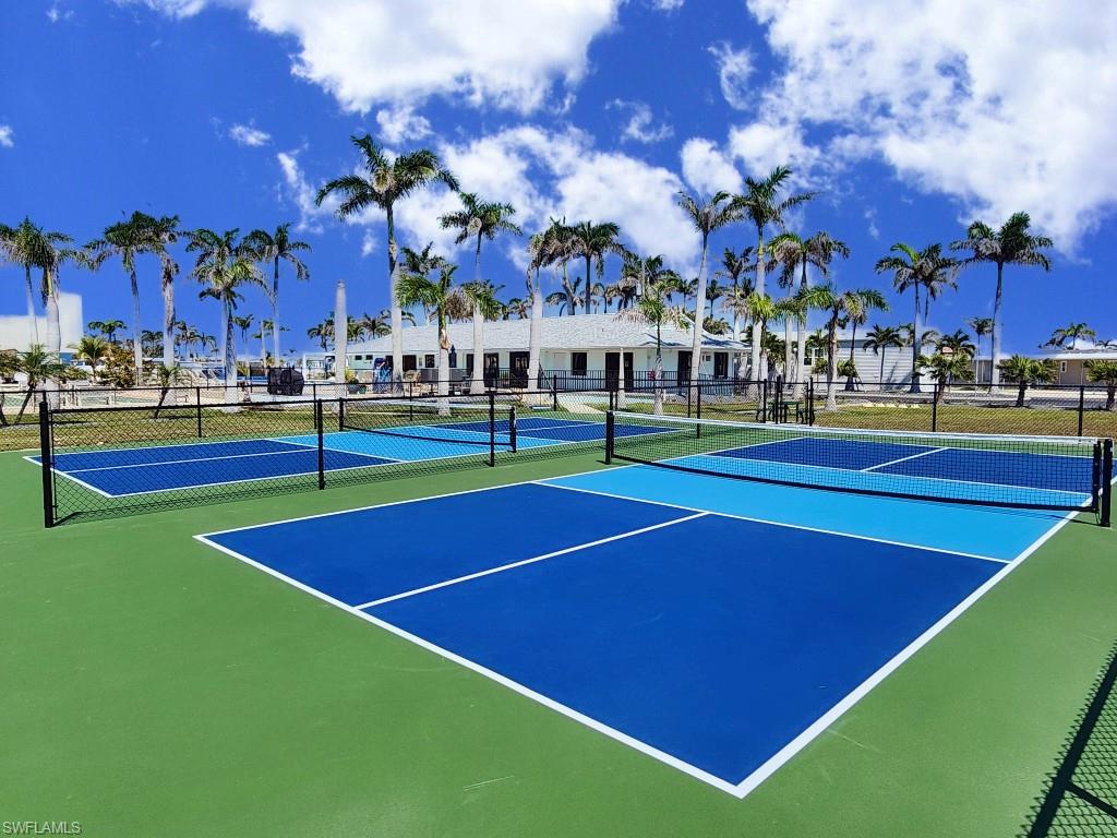 View of tennis court with community basketball court