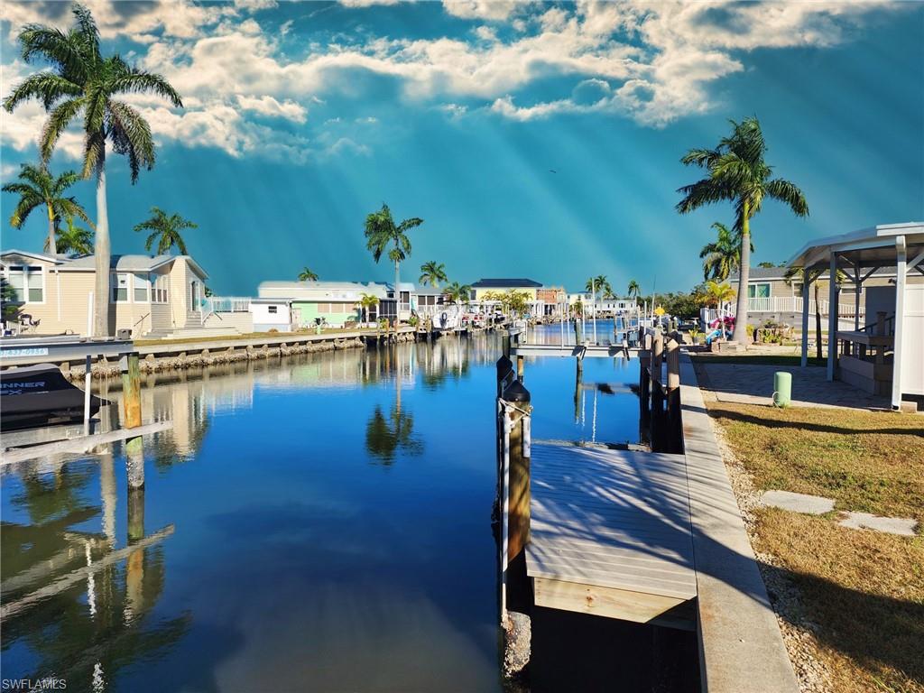 Dock with a water view and a residential view