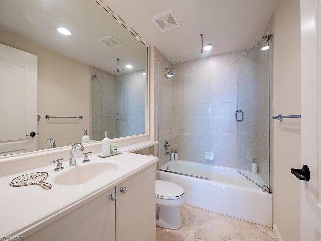 Bathroom featuring vanity, enclosed tub / shower combo, and recessed lighting