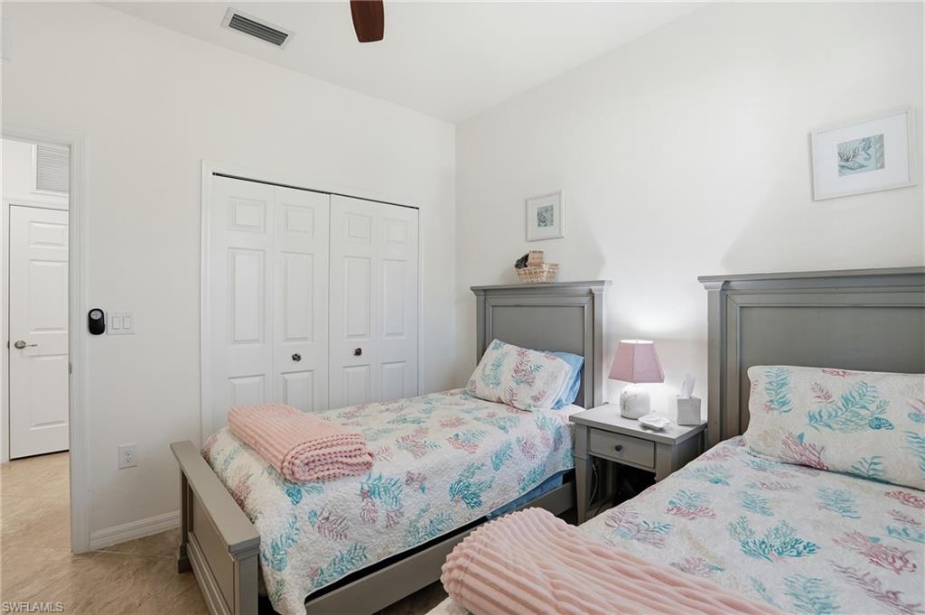 Tiled bedroom featuring a closet and ceiling fan