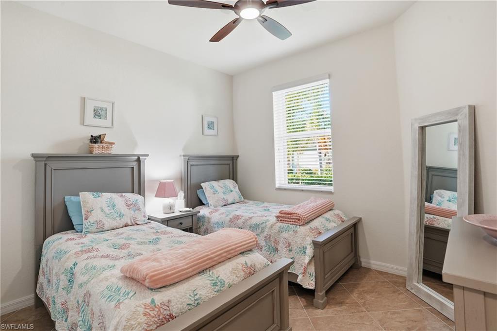 Bedroom featuring ceiling fan and baseboards