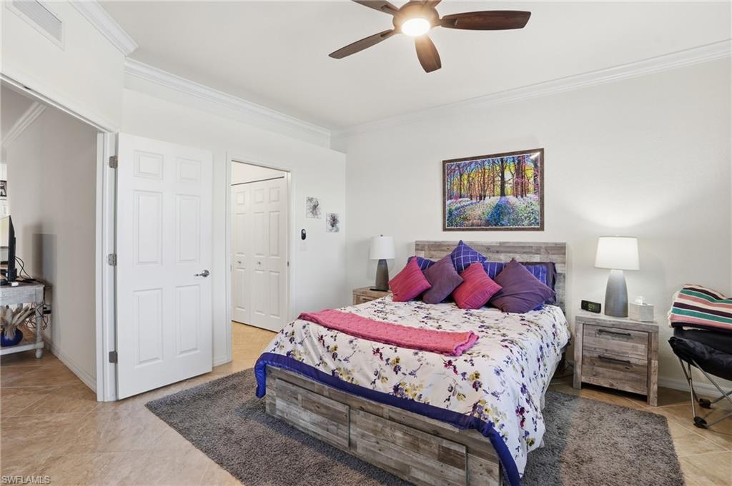 Bedroom with crown molding, a ceiling fan, and a closet