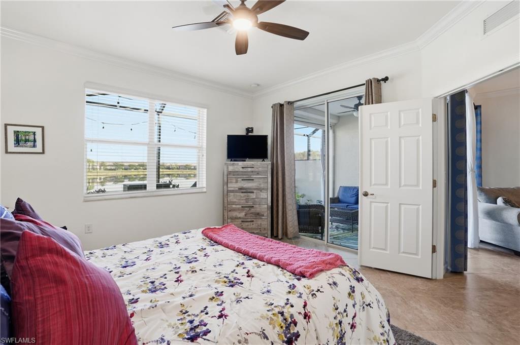 Bedroom with ornamental molding, access to outside, a ceiling fan, and light tile patterned flooring