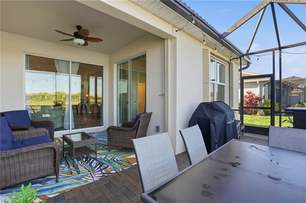 Sunroom featuring ceiling fan, a patio, and outdoor dining space