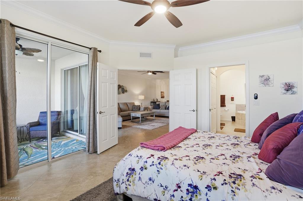 Bedroom with crown molding, ensuite bathroom, and a ceiling fan