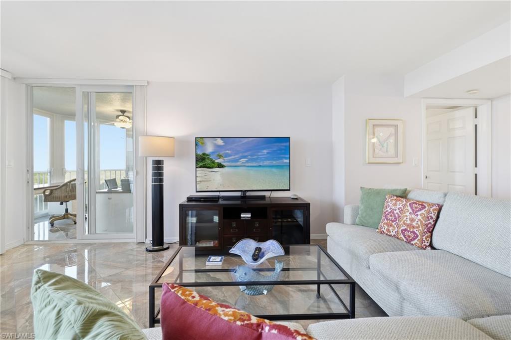 Living area with marble tiled floors and expansive windows