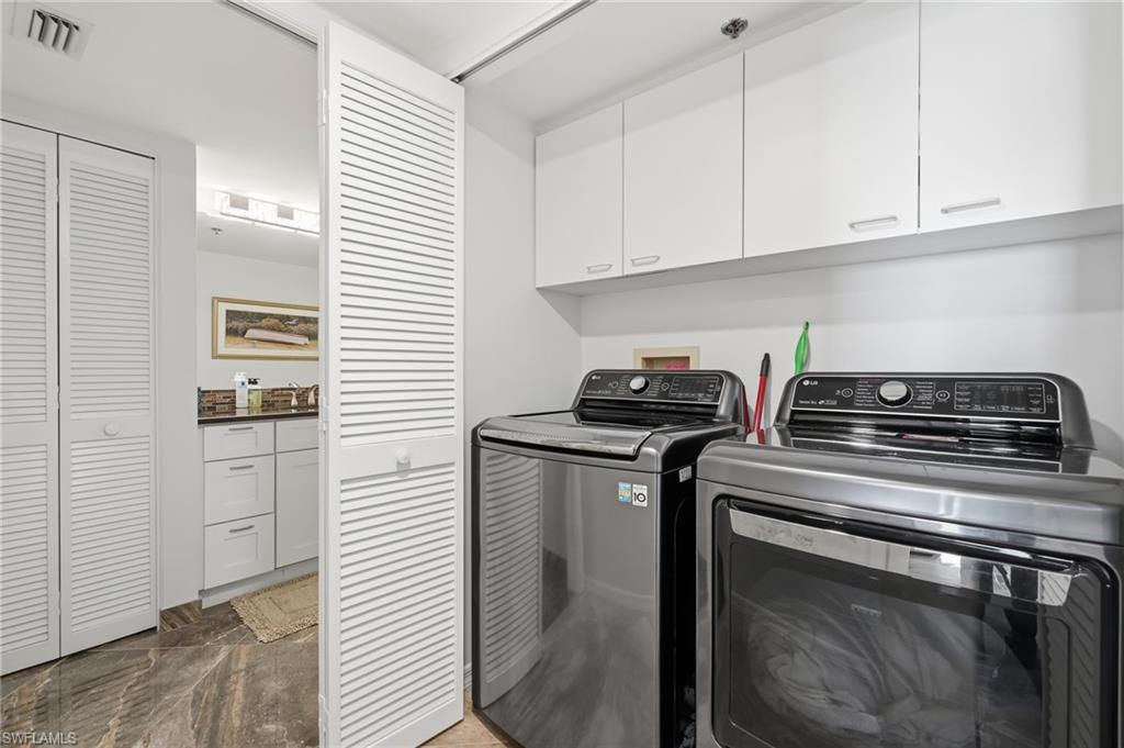 Laundry room with cabinet space and washing machine and clothes dryer