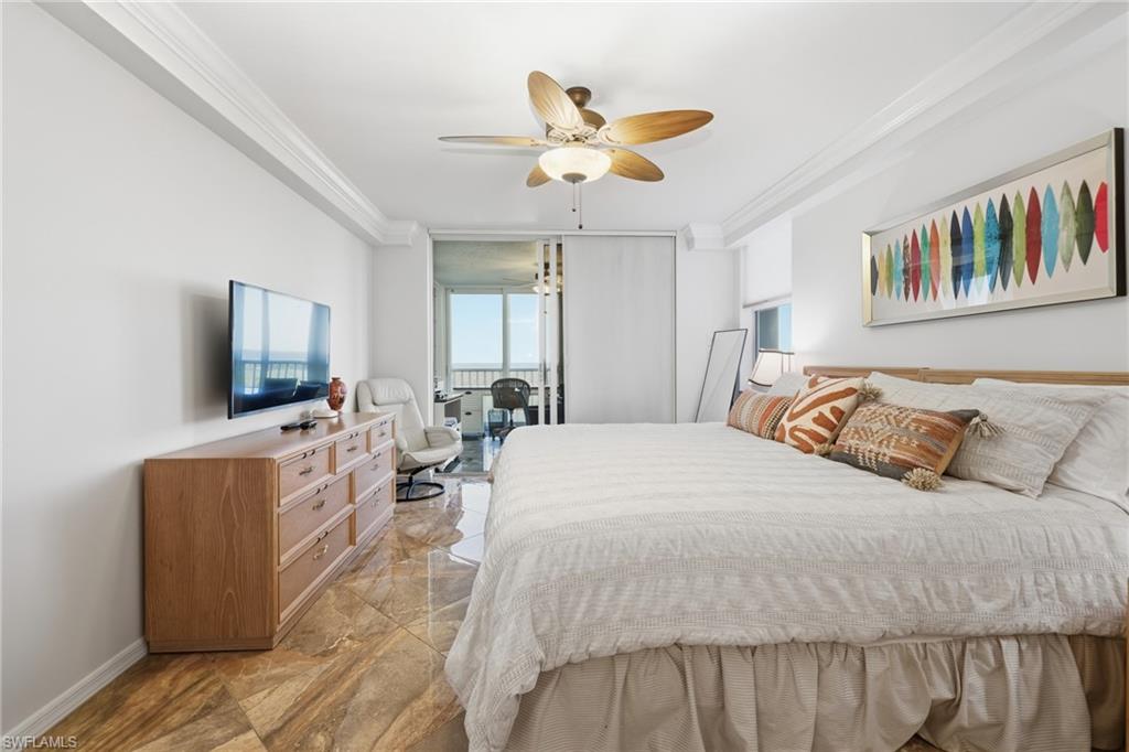 Bedroom with crown molding, a ceiling fan, and light marble finish flooring