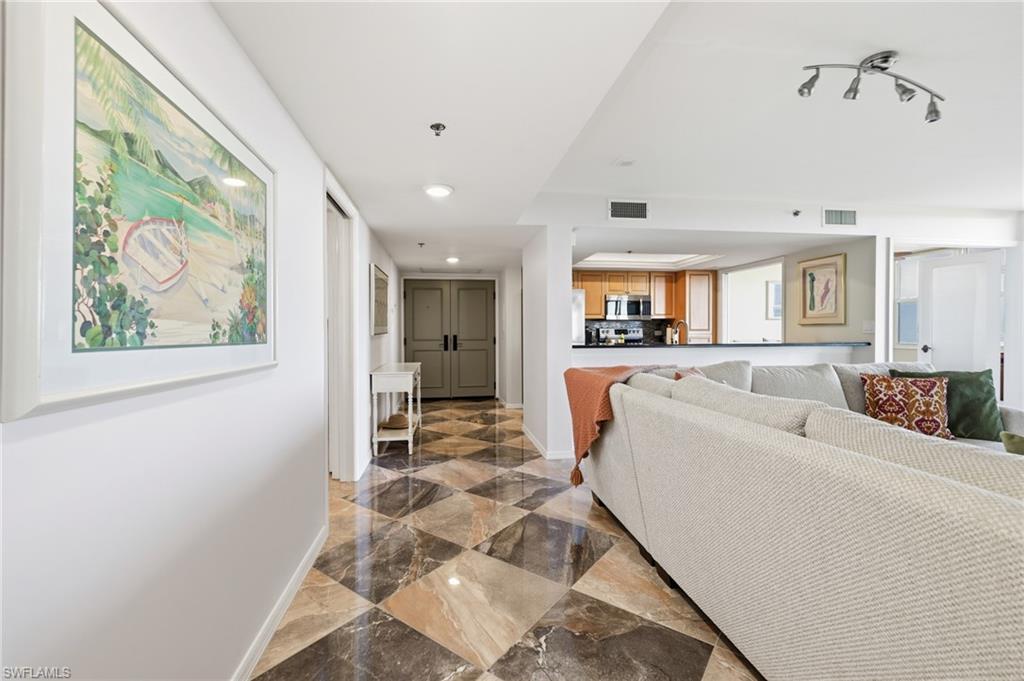 Living area featuring baseboards and recessed lighting