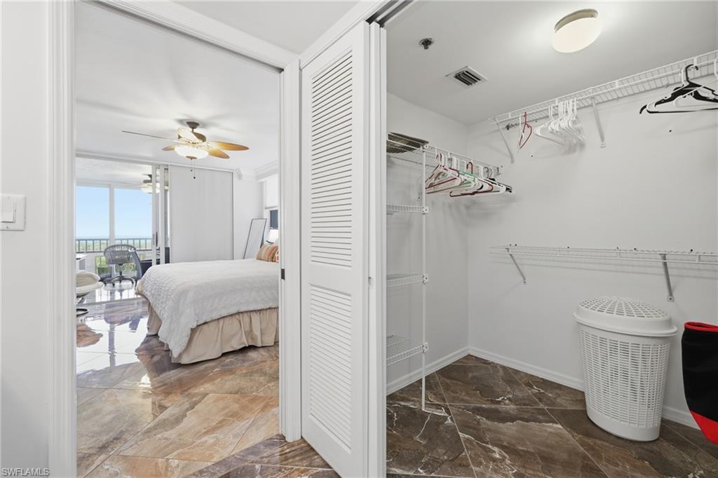 Spacious closet featuring a ceiling fan