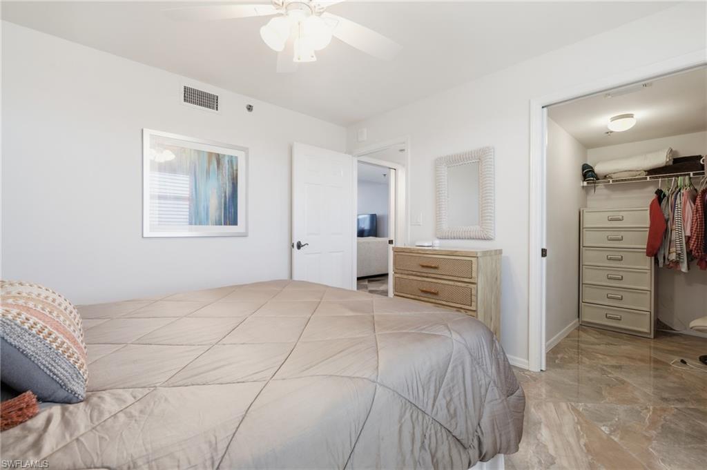 Bedroom featuring a spacious closet and a ceiling fan