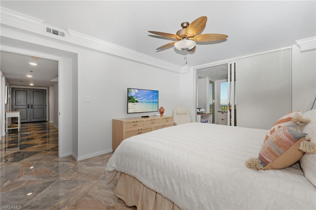 Bedroom with access to exterior, marble tiled flooring, a ceiling fan, and crown molding