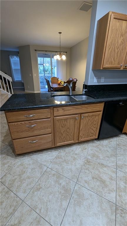 Kitchen with brown cabinetry, dishwasher, pendant lighting, a peninsula, and dark stone counters