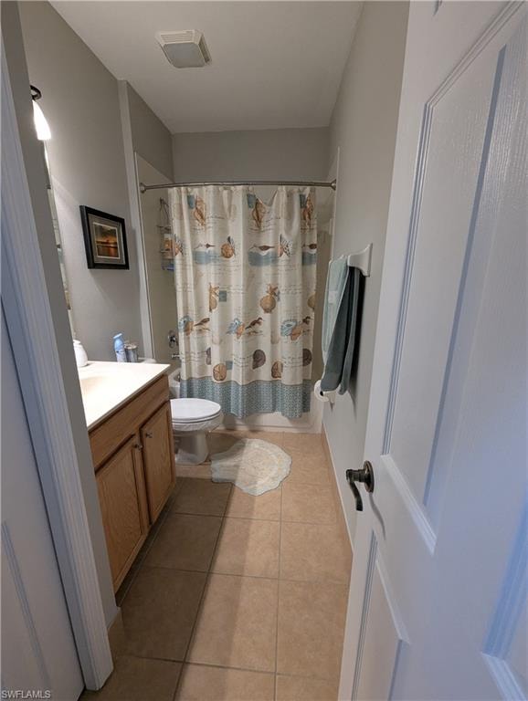 Bathroom with light tile patterned flooring, vanity, and shower / tub combo