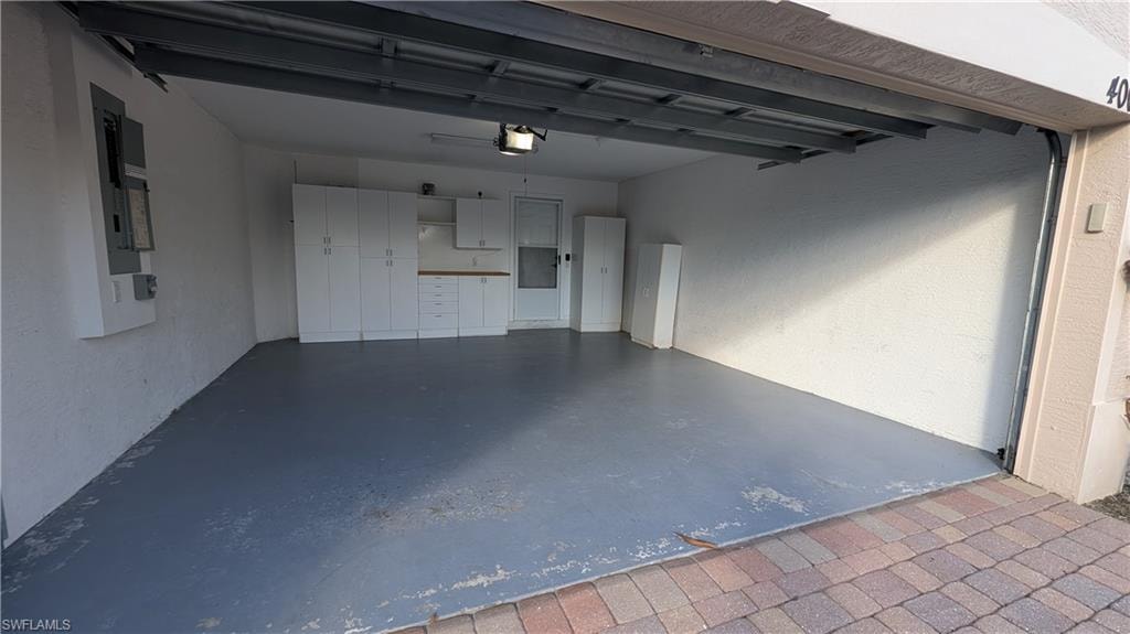 Garage featuring a textured wall and electric panel