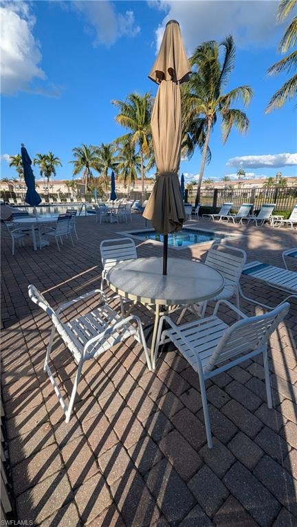 View of patio with a community pool