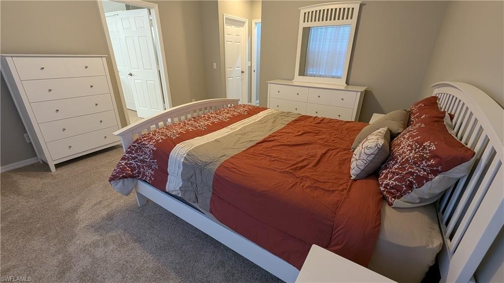 Carpeted bedroom with baseboards