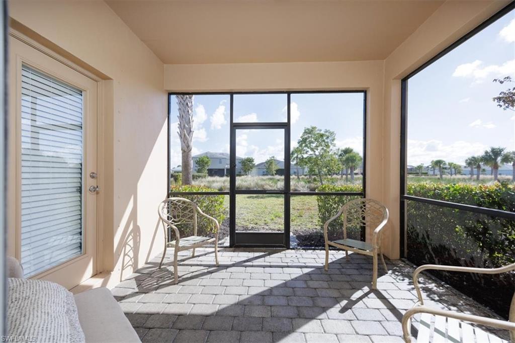 View of sunroom / solarium  Notice large expanse of common area separating neighbors to the rear for added privacy