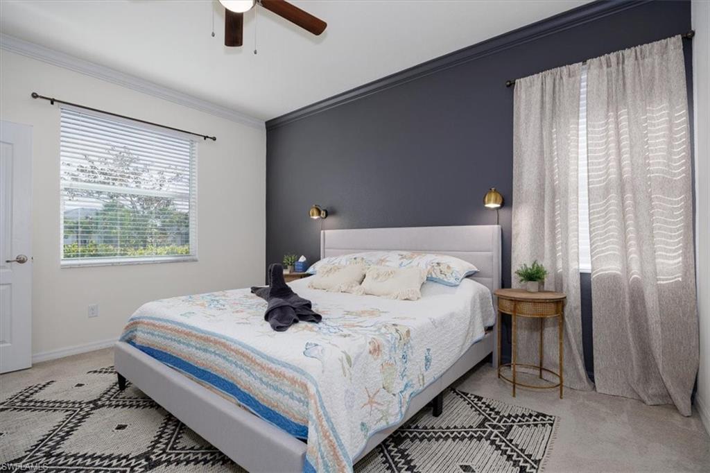 Owners Bedroom featuring ornamental molding and ceiling fan, Full bath, and walk in closet