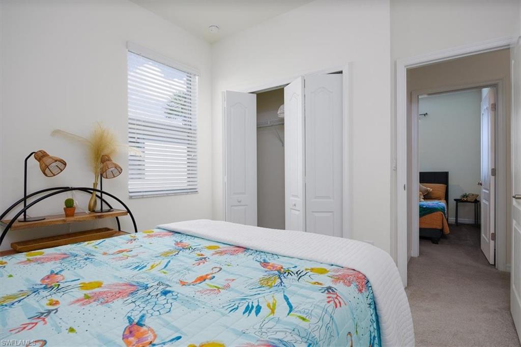 Carpeted Queen bedroom featuring a closet and Queen Bed