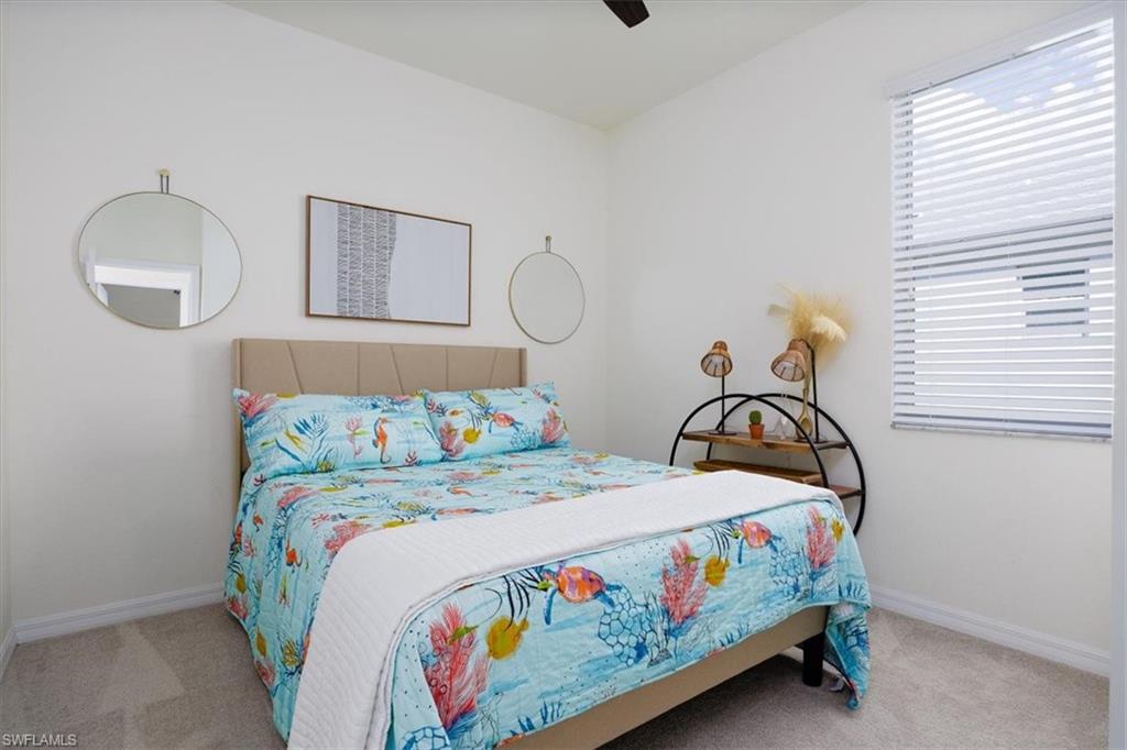 Bedroom featuring light colored carpet and a ceiling fan