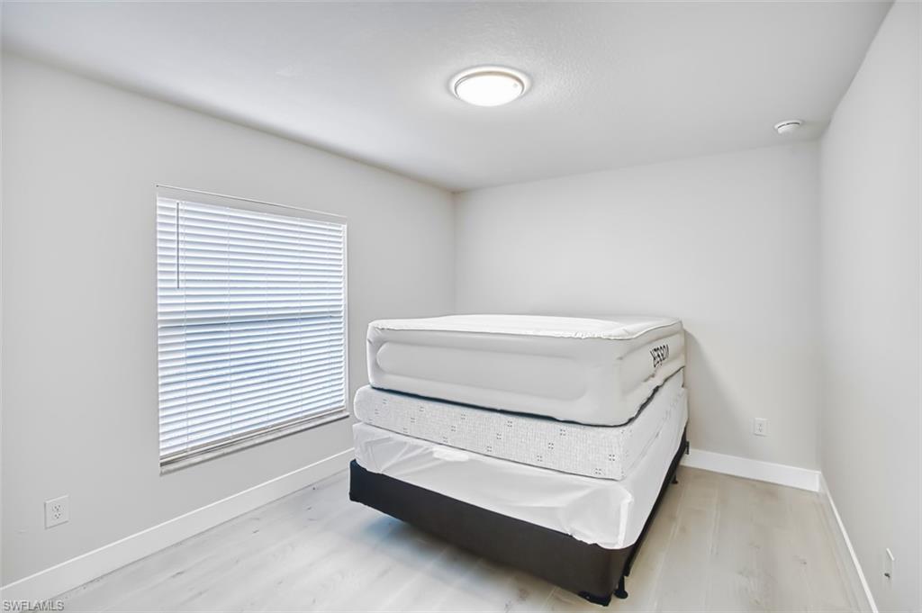 Bedroom featuring baseboards and light wood-style flooring