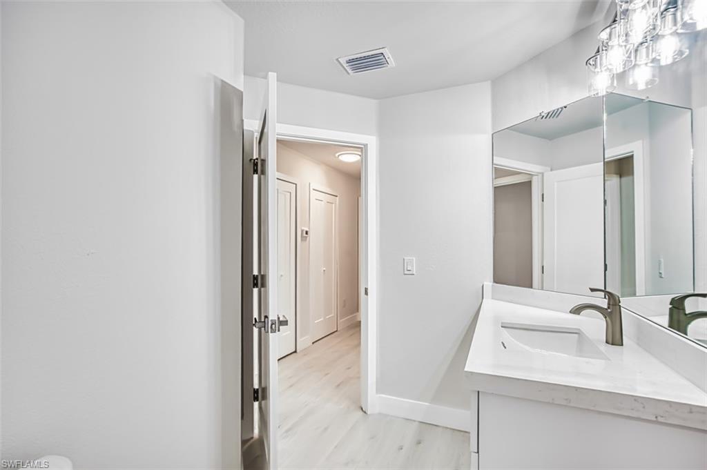 Bathroom with vanity and light wood-type flooring